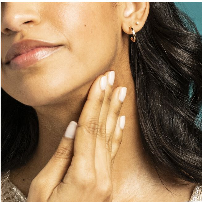 Woman using TL Advanced™ Tightening Neck Cream PLUS 